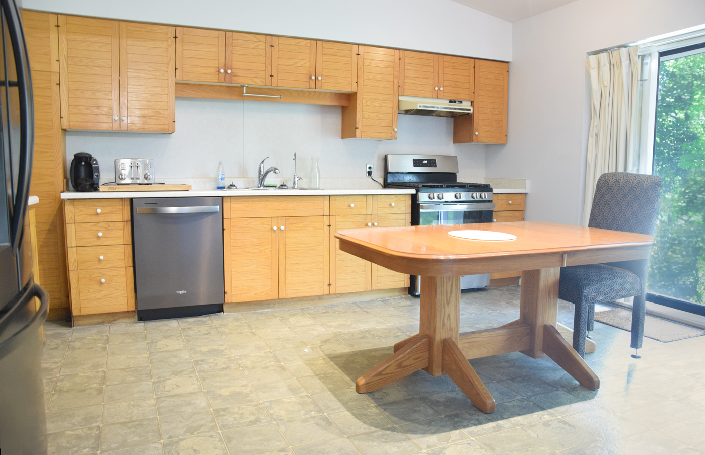 Kitchen with stove, dishwasher and dining room table